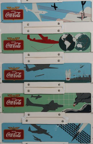 COCA-COLA KAY DISPLAYS WAR PLANES FESTOON: Each piece measures 5 3/4" x 27", construction is masonite, being sold without the pressed composition gold planes or the braided cord; very strong, bright and unused condition with only the most mino