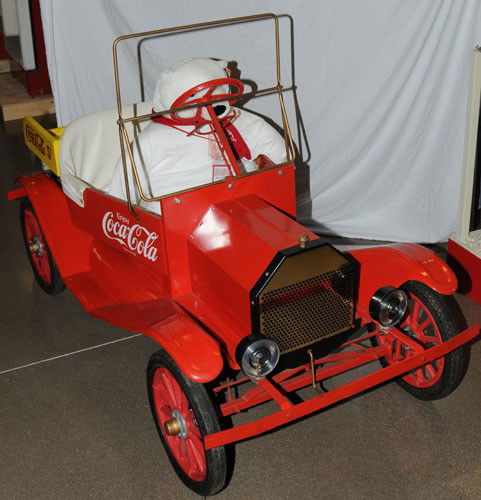 CHILD'S COCA-COLA GAS POWERED MODEL T: 72" long, post 1975 era; sharp 1/2 scale replica vehicle, manufactured by Crue-Cut of Kansas City; seats two small children; has Briggs & Stratton 3.5 horsepower 148 cc engine; the vehicle is metal wi