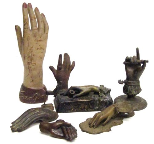 (8) PCS. HAND COLLECTION: Includes: (1) bronze pen holder, signed illegibly; (1) cast iron paper weight; (1) spelter cigar lighter; (1) bronze double hand; (1) stamped brass paper clip; (1) fragments; (1) composition Sonn Glov