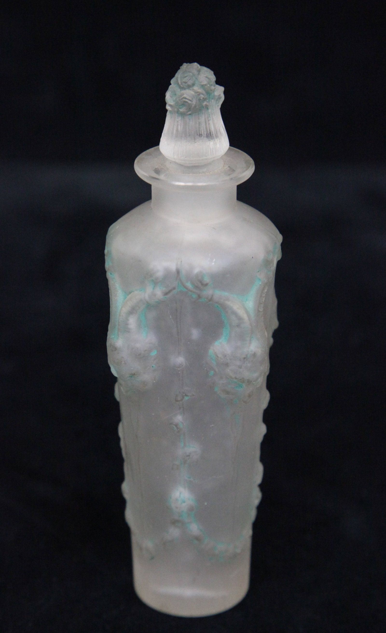 "PAN" LALIQUE PERFUME: Embossed masks and drapery, embossed R. LALIQUE, stopper stuck; wear, traces of highlights; H-5", G