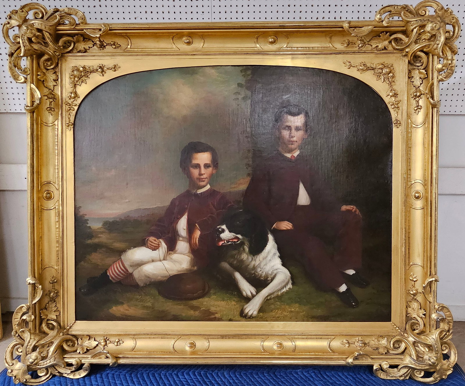 A. G. POWERS PORTRAIT PAINTING: Monumental portrait of two brothers and their dog in a landscape; oil on canvas; circa 1868, signed lower left; extremely ornate openwork gold leaf period frame; relined; image 42" x 56"; framed 62" x