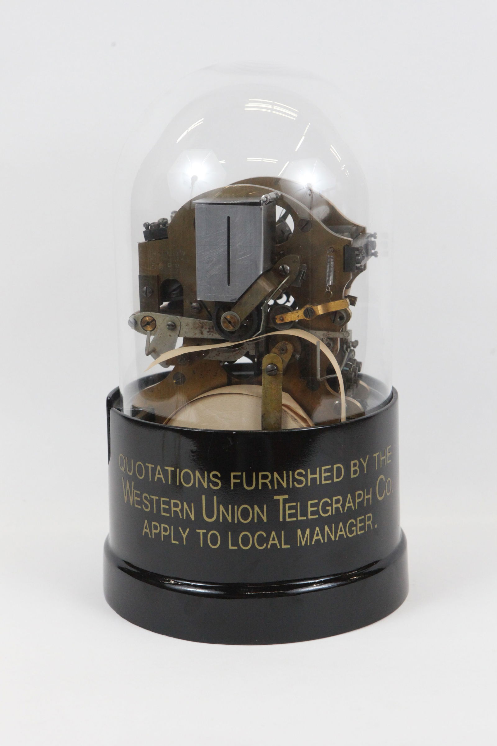 ANTIQUE SELF-WINDING WESTERN UNION STOCK TICKER: Rare self-winding ticker tape machine circa 1920-1930; together with original roll of ticker tape; stamped "J. H. BUNNELL & CO NEW YORK, U.S.A. 5988", base labeled: "Quotations Furnished by the Wester