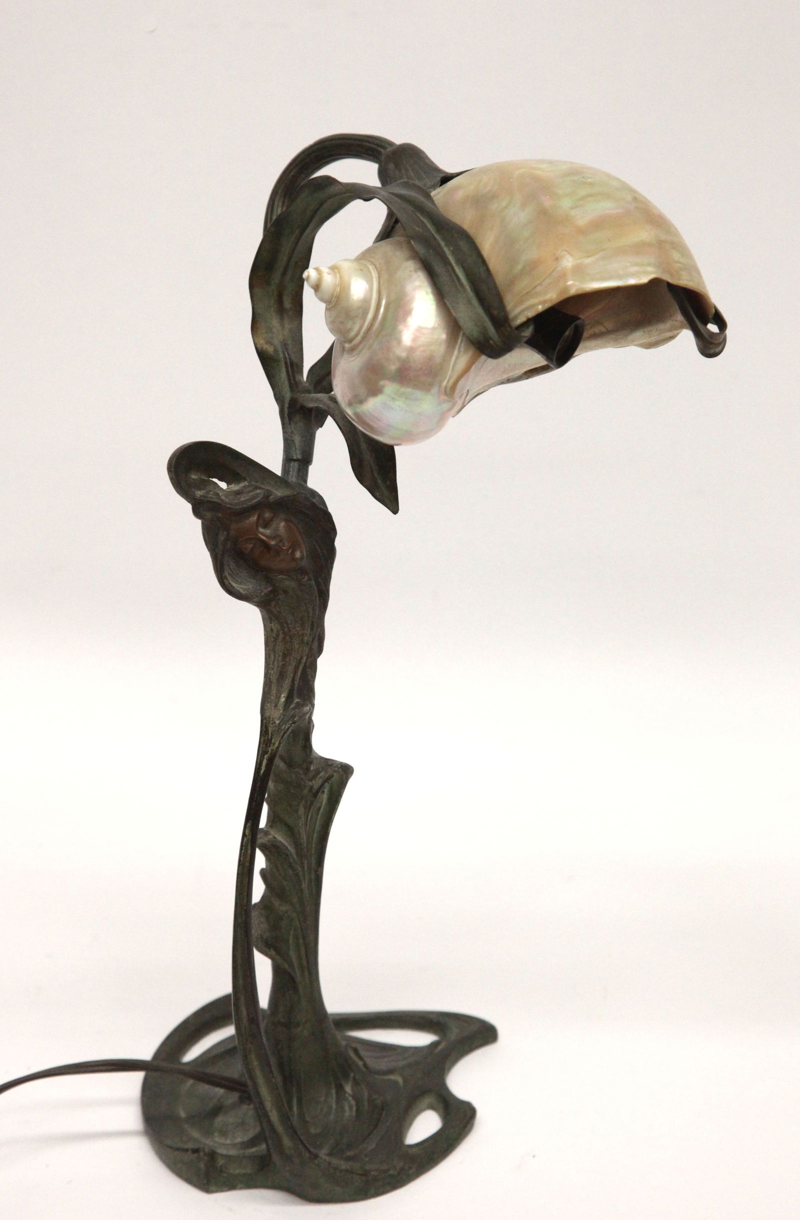 ART NOUVEAU LAMP: Nautilus shell on cast bronze patinated floral base with woman' sface; normal wear; H-16", G-VGLAMP IS POT METAL - NOT BRONZE