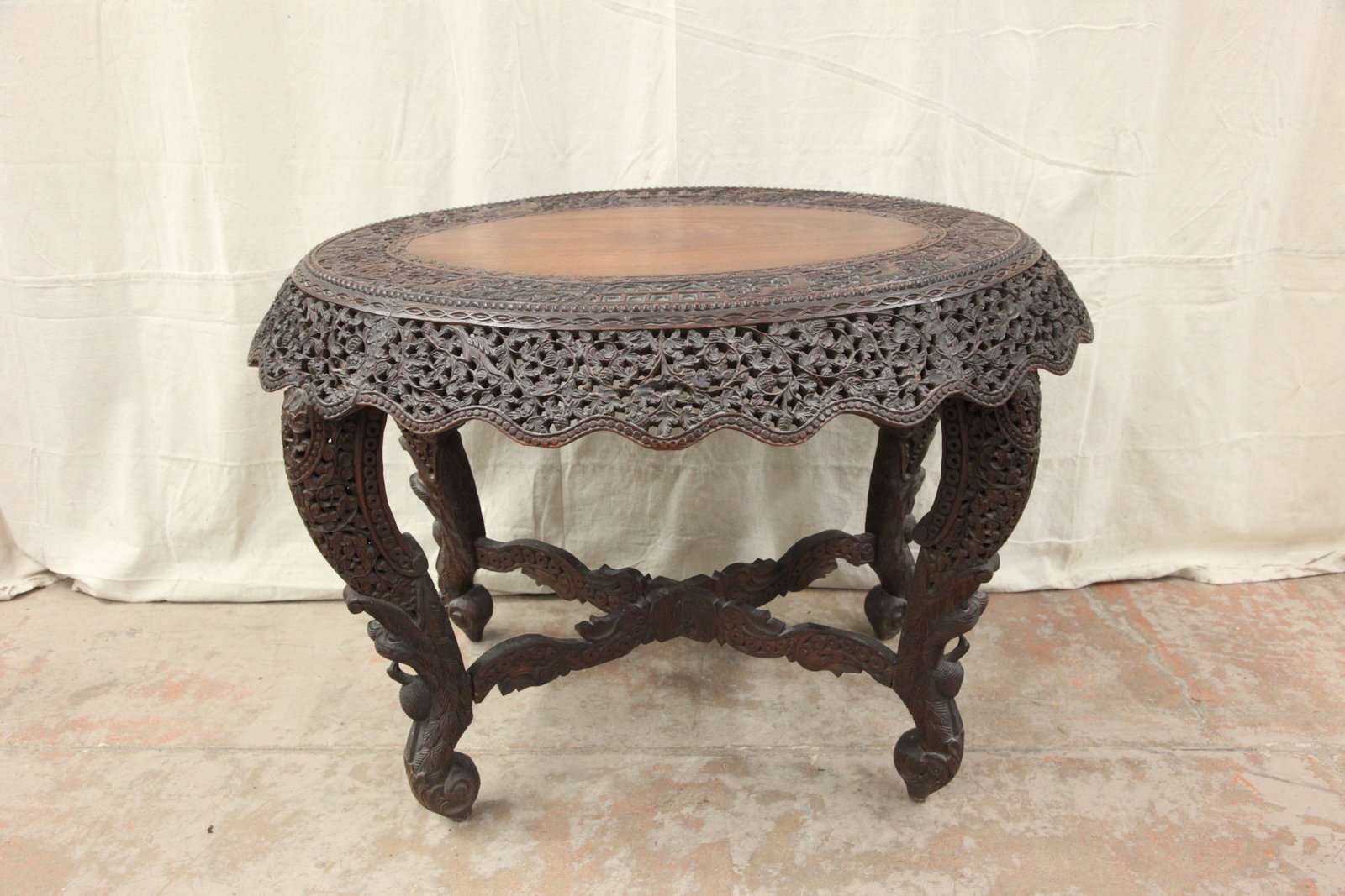 INDO-PORTUGUESE CENTER TABLE: Rosewood (?), oval table with elaborate carvings and openwork decoration, normal wear, H-30", L-40", G-VG