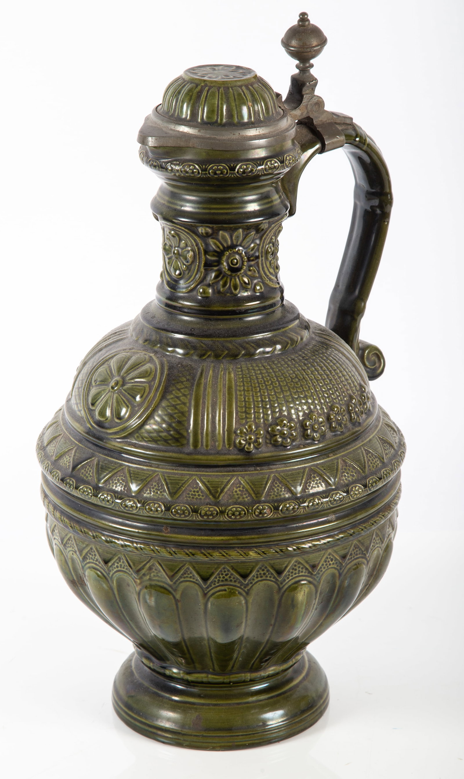 MAJOLICA TANKARD PITCHER: Dark olive green glaze; relief decoration; script L mark, pewter hinge, minor base flake; H-16", G-VG