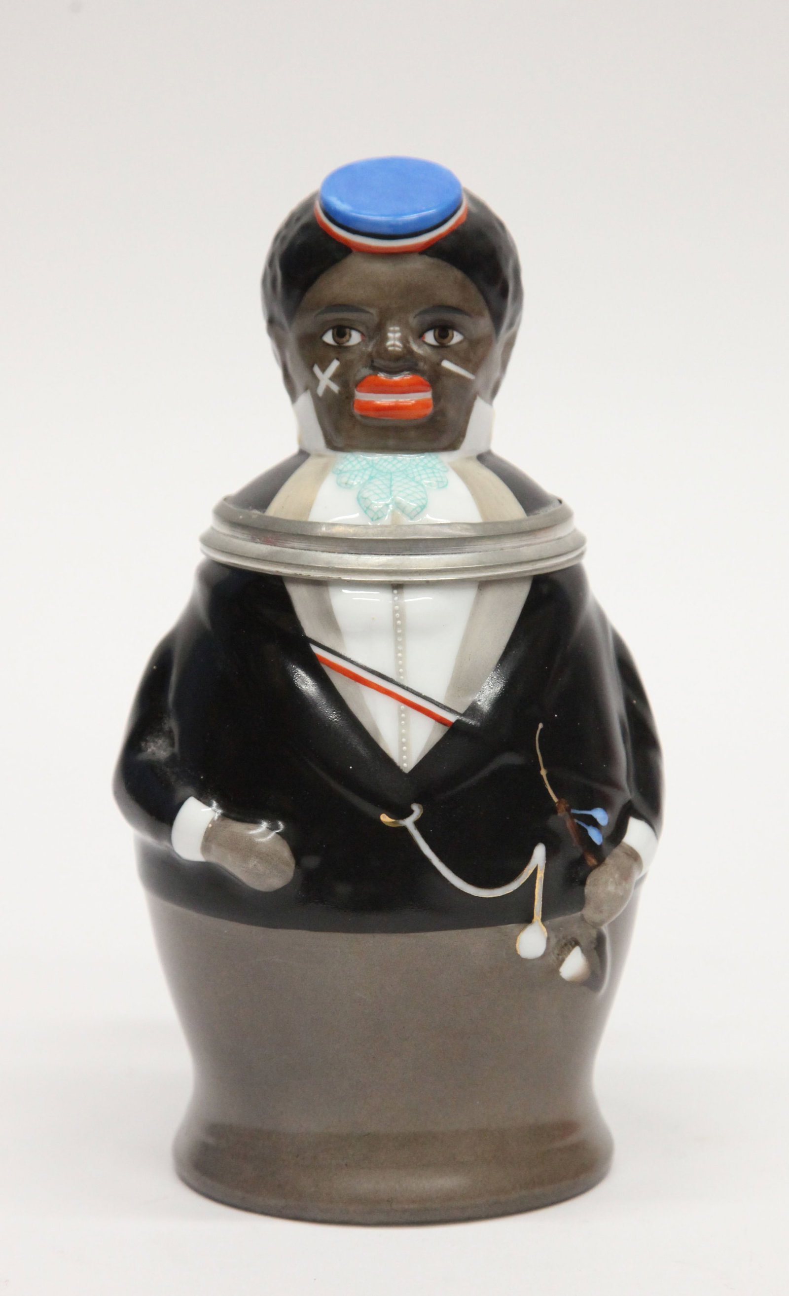 BLACK GENTLEMAN STEIN: Painted porcelain figural stein; lithophane bottom; L.B.C.M. on pewter; firing hairline in bottom; does not affect the lithophane; H-8", G-VG