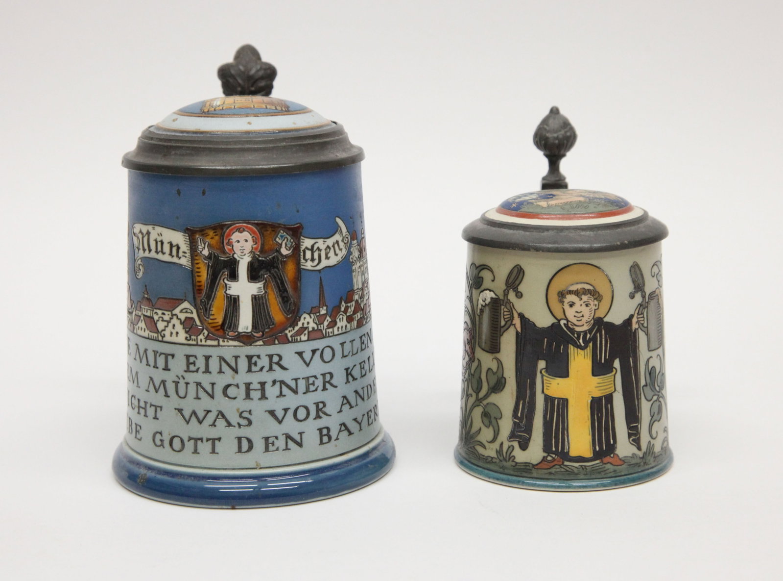 METTLACH PRIEST STEINS (2): Painted ceramic with inset ceramic lids; (1) 2002 Munich, 1/2 Litre; (1) 2052 cherub lid, 1/4 litre; normal wear; G-VG