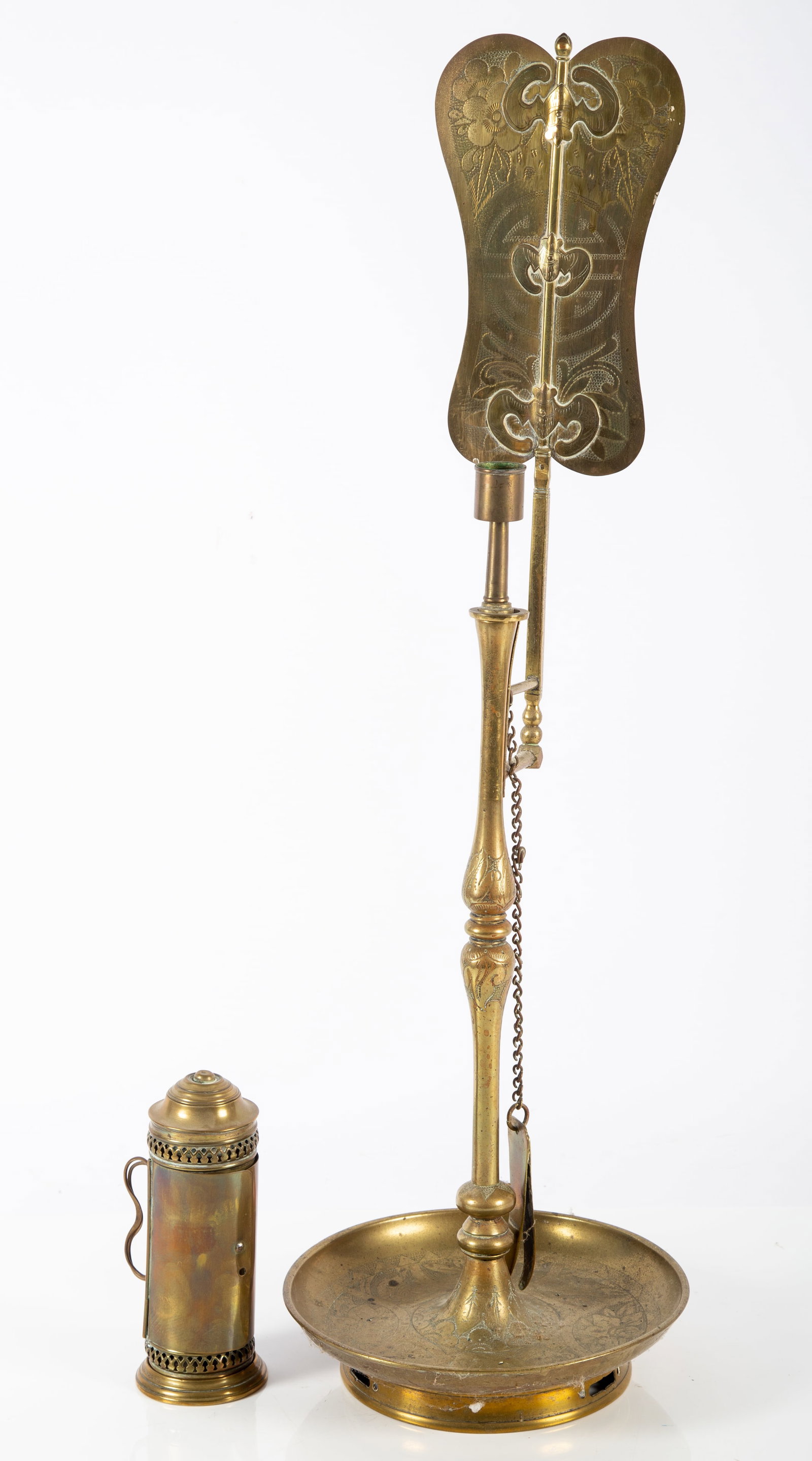 ANTIQUE BRASS LIGHTING (2) PCS.: (1) tall candlestick, revolving, reflector with bat shaped relief ornamentation; floral and geometric engraving, H-26"; (1) small candle lantern, hinged door; double wire handle, H-7", G