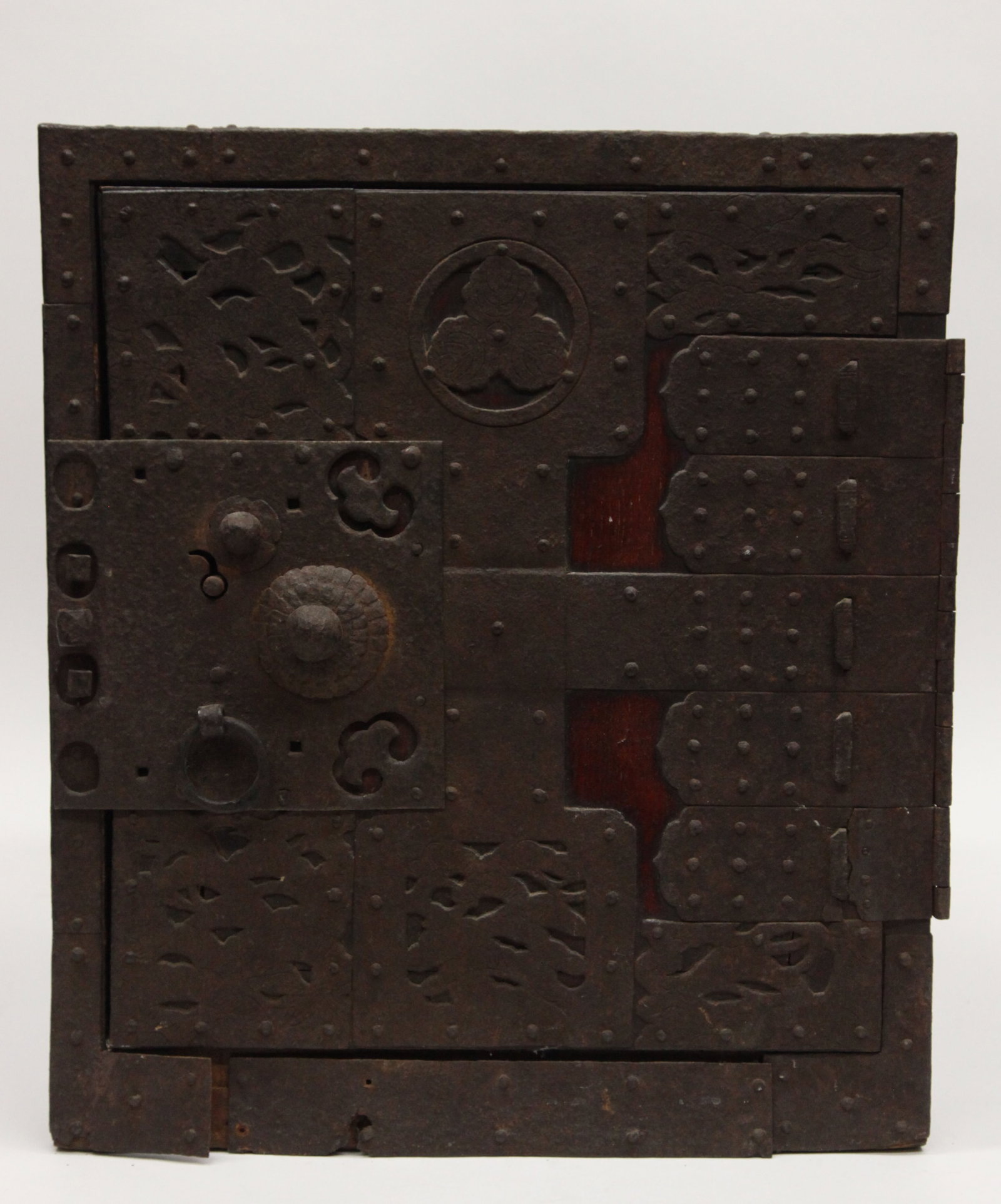 ASIAN BOX: Teak (?), metal banded with ornate door; five interior drawers, (1) with lock but no key; lower band separation; rust and wear; no exterior lock; H-16", L-14", F-G