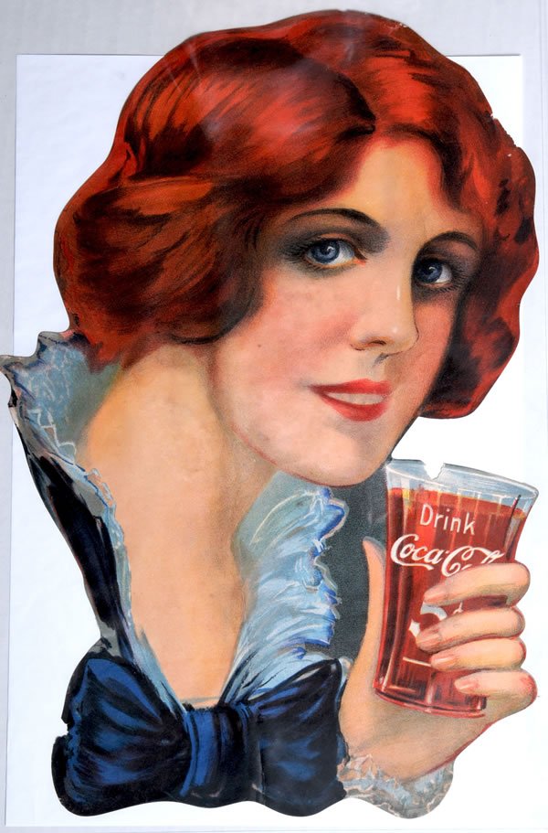 1912 TO 1913 RARE COCA-COLA PAPER SIGN CUT-OUT: 16" x 10 1/2". Beautiful color, great image. Very minor small chip at the top of the glass. Some miniscule edge chips and nicks. Light soiling and a few faint stains and minor spots. Condition 7.5+ / 