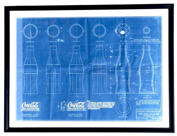 1920'S COCA-COLA BOTTLE BLUEPRINT SHEET: Matted and framed under glass, visible image measures 16 1/2" x 23". Nice detail and cross sections of the hobble skirt bottle are shown. Some fold lines and marks as well as edge wear and light surfa