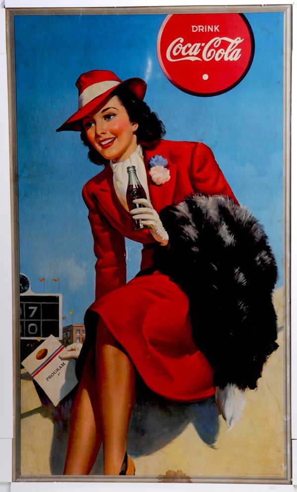 1940 COCA-COLA LARGE VERTICAL CARDBOARD POSTER: 50" x 30". Slightly darkened with medium soiling. Some minor surface rubs and marks, darker stain bottom center border area. A few other surface scratches and edge wear. Condition 7 to 7.3 / VG