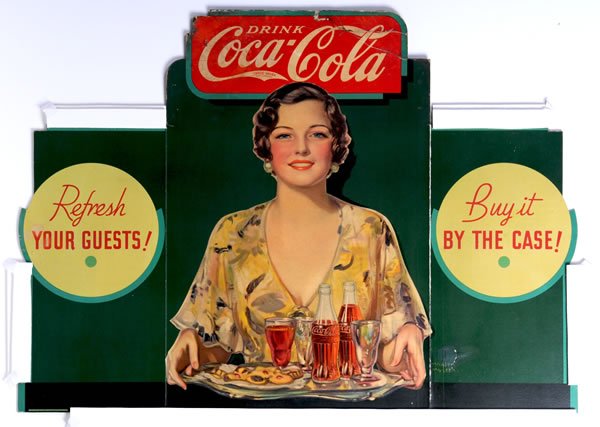 1934 COCA-COLA CARDBOARD TRI-FOLD CUT-OUT: 31" x 43". Great color with good overall appearance, however there is a touched-up and rebuilt spot around the signature of Hayden Hayden on the right side, as well as some heavy soiling, strong bends