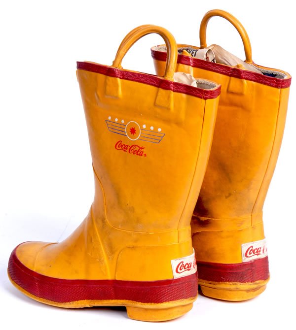 SCARCE COCA-COLA CHILDREN'S RUBBER BOOTS: Circa 1950's to 60's. 10" tall. Very unusual to find with general overall wear. One of the pull-on loops is missing on the right shoe, with one of the connecting points separated on the left shoe. Oth