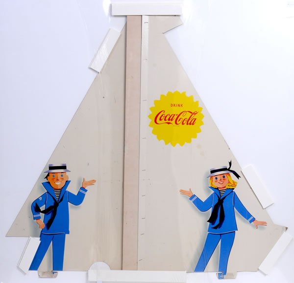 RARE & UNUSUAL 1960'S COCA-COLA SAILBOAT DISPLAY: 43" x 42" x 20" deep. The base of the boat is made of corrugated cardboard and is designed to fold-up like a box lid. After that is accomplished, the boy and girl and sail would be inserted, the flags