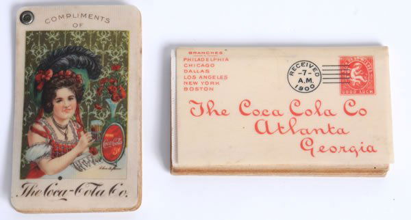 1900 AND 1902 COCA-COLA CELLULOID STAMP HOLDERS: 1 1/2" x 2 1/2". The 1900 example has had its staple removed by the archivist in the past. Complete with a full year calendar with a separate page for each month as well as numerous dividers for stamp