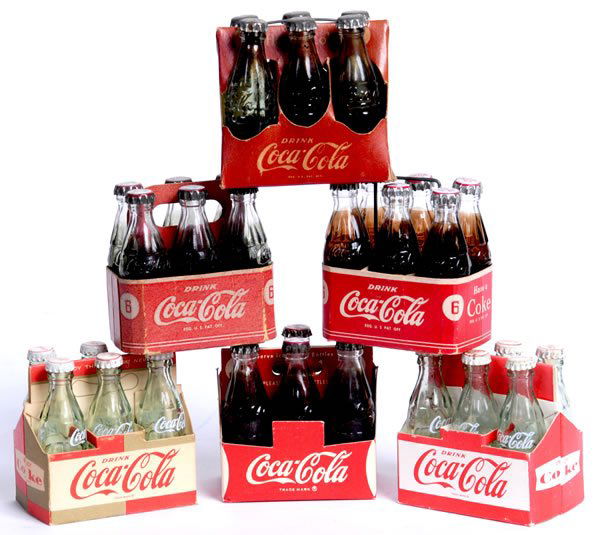 6 COCA-COLA MINIATURE SIX PACKS: 2 1/2" x 2 1/2" x1 3/4" avg. each. 4 of the 6 are marked Bill’s Novelties. 1940s-60s. Glass bottles and metal caps. Light to medium wear, soiling, and fading, with tape on one side of an early carri