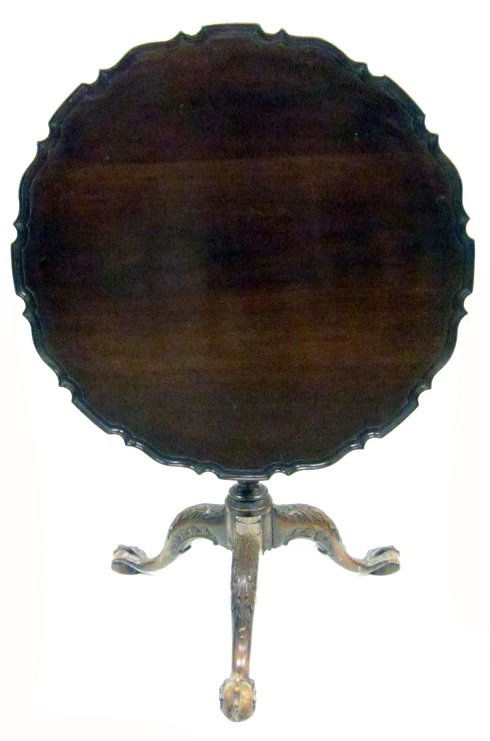 CHIPPENDALE STYLE TILT TOP TABLE: Mahogany; pie-crust top; bird cage; elaborately carved pedestal and knees; egg and claw feet; normal wear; H-28", Dia.-33 1/2", G-VG