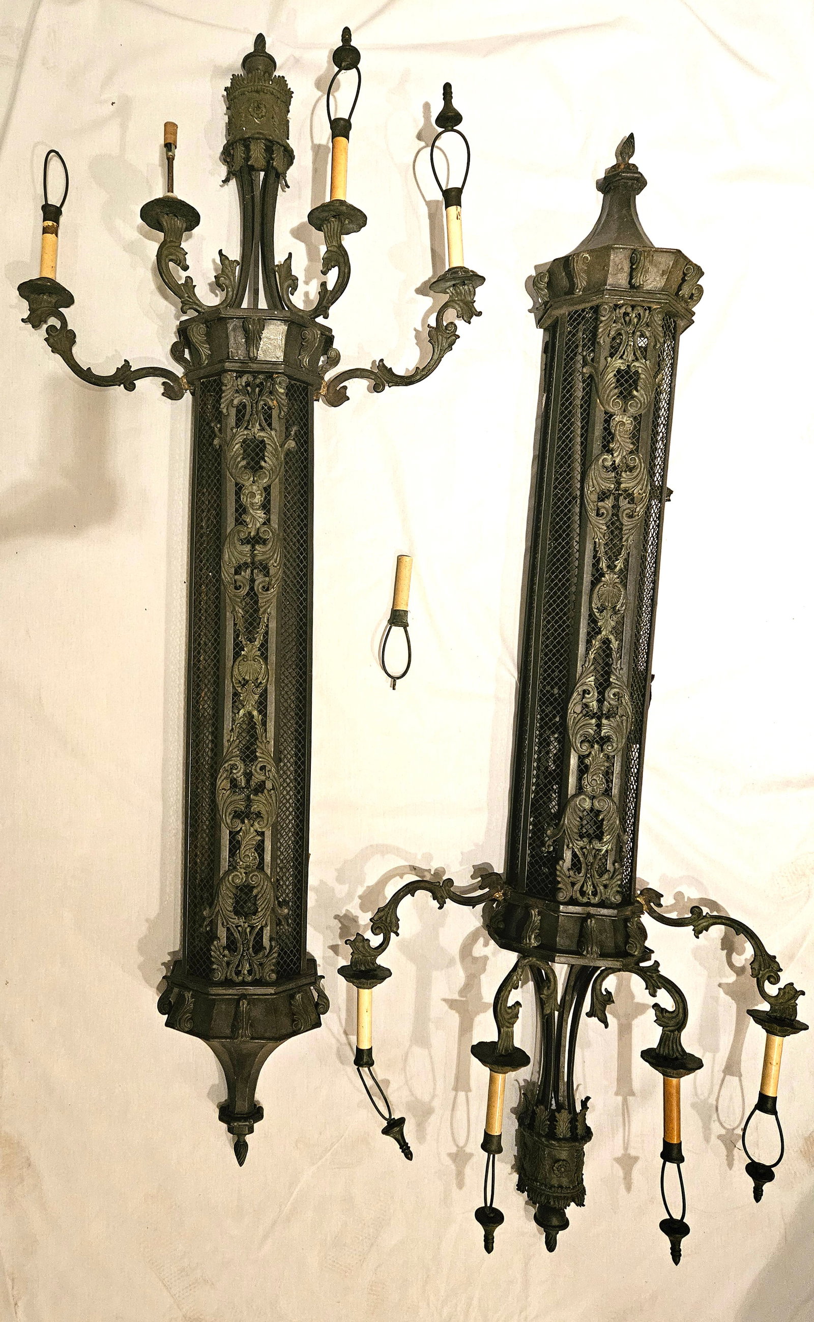 DECORATIVE ENTRANCE FIXTURES: Pair wrought and cast metal tall sconce-style light fixtures; purportedly used on the set of "Hannibal", (sequal to Silence of the Lambs), normal wear; H-87", G