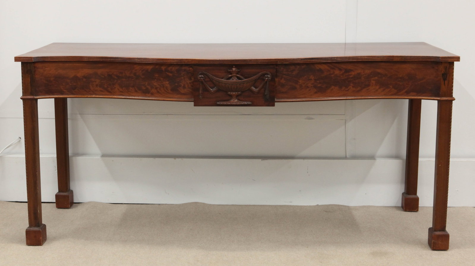 MAHOGANY SIDEBOARD: Chippendale style; serpentine, reeded edge, carved compote cartouche, square legs with block feet; some surface wear and blemishes; H-31", L-66", G-G+