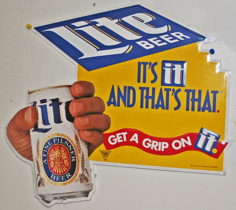 (2) TIN BEER SIGNS: (1) Lite Beer tin sign: embossed die-cut; hand holding can of Lite Beer with slogan "Its It and That's That"; 16" x 19"; (1) Coors Light tin sign: embossed die cut, can of Coors Light with ice; 35" x