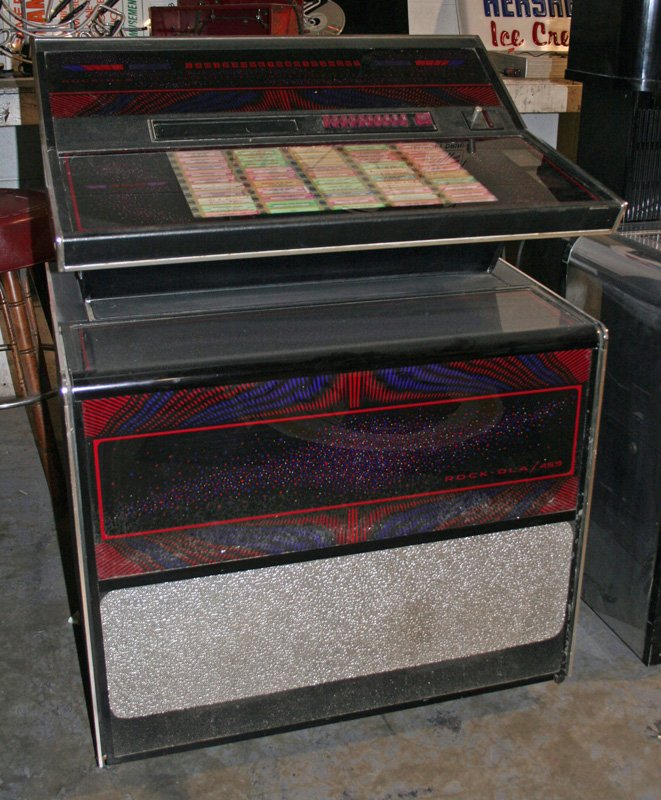 COIN-OP ROCK-OLA MUSIC SYSTEM: Integrated circuit / solid state / stereophonic; chrome, glass and wood; as is; H-47", W-34", G