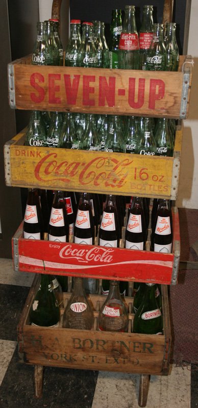 SODA CRATES, BOTTLES & DOLLY: Bortners Crate and bottles, Coca-Cola crates and bottles; 7-UP crate; metal dolly; H-48", G