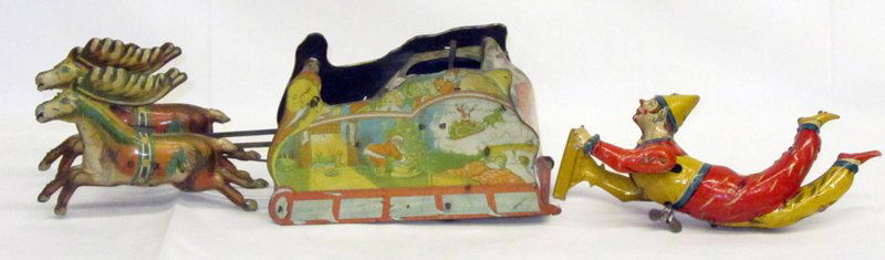 TIN LITHO WIND-UPS (2) PARTS ONLY: (1) German Clown: marked J.A.J. on ankle, runs, (1) broken piece missing on right hand; minor scuffs overall; (1) "Santee Claus": Strauss Corp; runs; missing parts (Santa and reindeer); scratches and