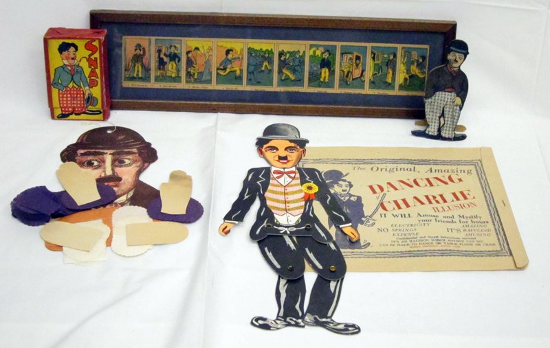 CHARLIE CHAPLIN PAPER EPHEMERA & GAMES (5): (1) Dancing Charlie illusion doll: litho cardboard with original envelope; (1) crepe and card stock hanging puppet; (1) Charlie squeak toy: Japan cardboard litho; (1) game "Snap" in original box; (1) 