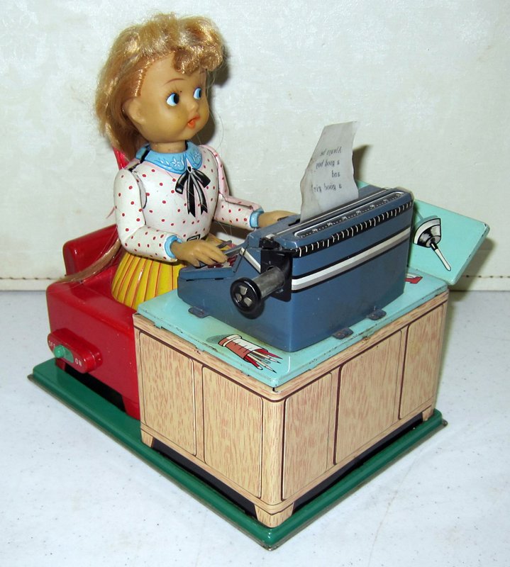 LINEMAR BUSY SECRETARY BATTERY OP: Japan; litho tin with vinyl hands and face; runs with all actions and letter pops up and down in Tom Thumb Typewriter; H-8", VG-EX