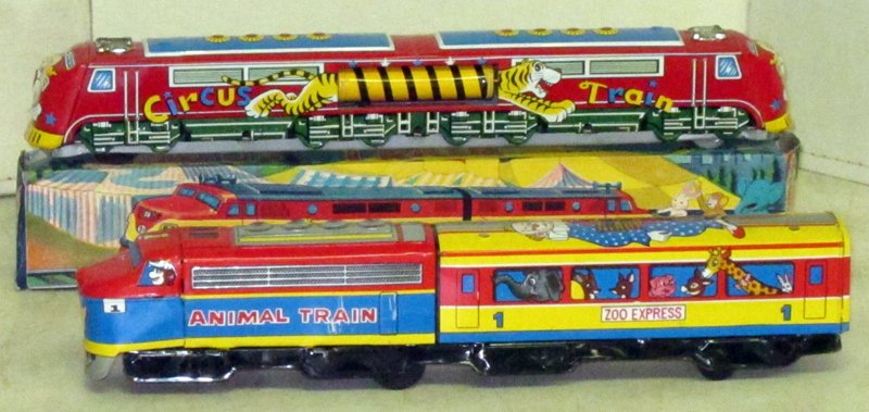 CIRCUS & ANIMAL JAPANESE TOY TRAINS (2): (1) Circus Train: SKK, litho tin, friction, runs; tiger body in center of train spins, original box VG-EX; (1) Animal Train - Zoo Express: Shudo, friction, runs with siren sound, L-15", EX-NM