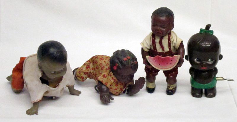 BLACK AMERICANA WIND-UP TOYS (4): Celluloid and hard plastic, all run sporadocally; watermellon boy missing dog; smallest black girl damaged; H-4"-6", F-G