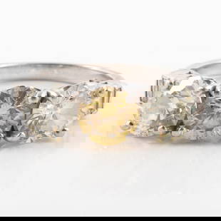 CANARY YELLOW DIAMOND RING: Platinum setting, center stone is a GIA certified 1.01 carat natural fancy yellow diamond, round brilliant cut; set between (2) 1.1 carat each transitional cut round diamonds, VS2, G-H-I color; (6) ba