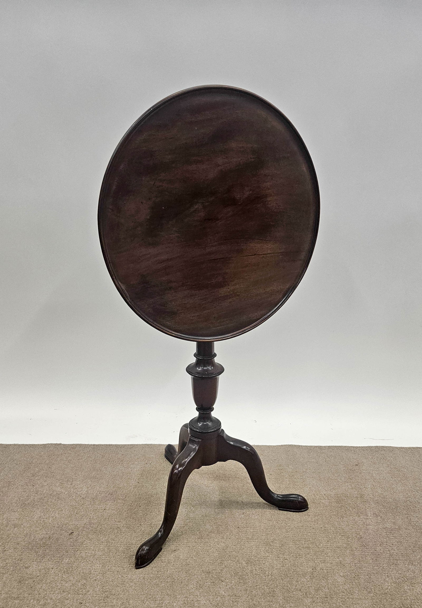 QUEEN ANNE STYLE TEA TABLE: Mahogany; tilt top, turned pedestal; quality reproduction; minor rubs; H-29", Dia.-19 1/2", VG