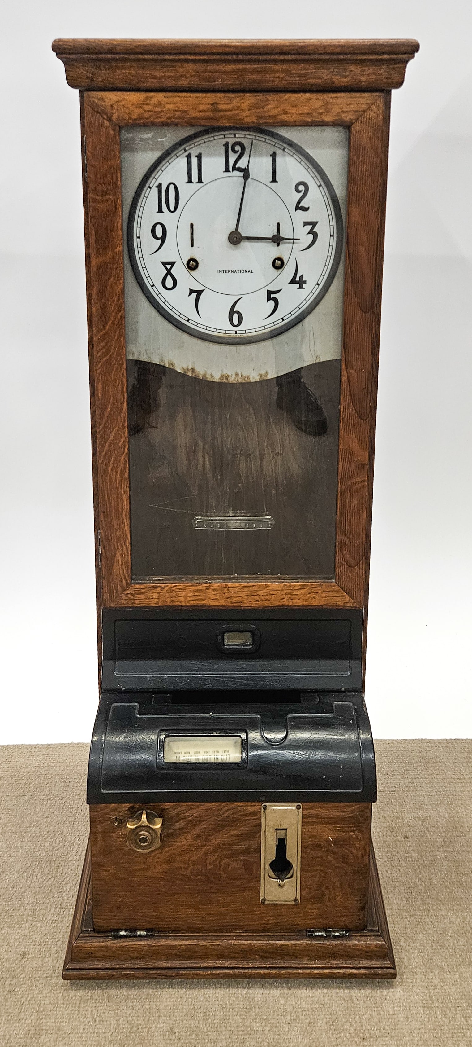 INTERNATIONAL TIME CLOCK: Punch card wall clock; quartersawn oak; retains keys and pendulum; normal wear; H-43", 11.5" x 16", G-VG