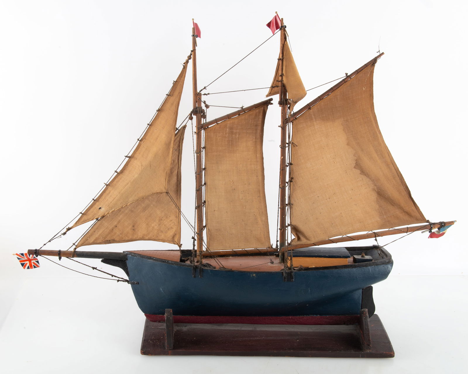 ANTIQUE BOAT MODEL: Carved and painted wood; three masts with sails; normal wear; H-21", L-29", G-VG