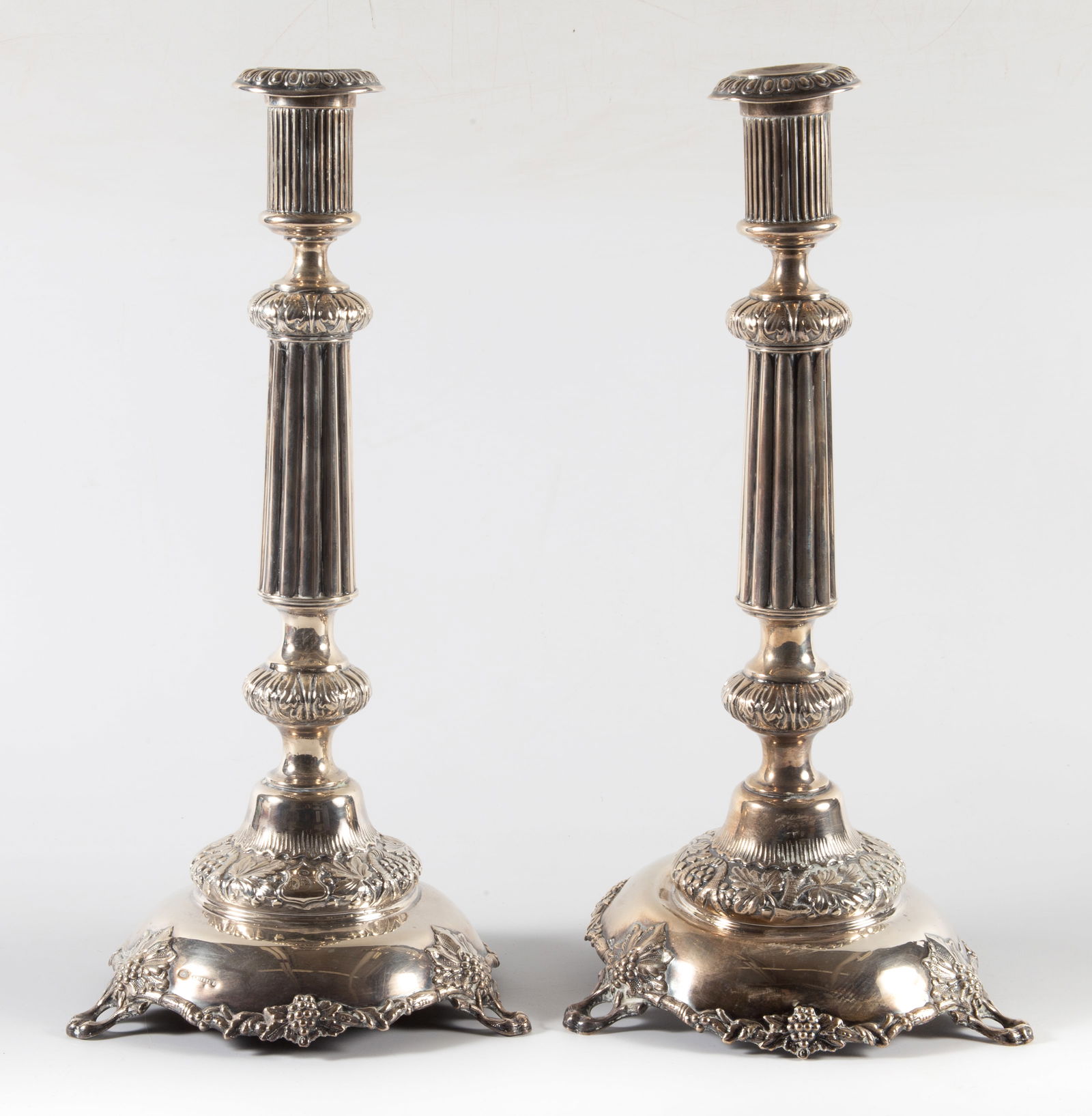 PAIR OF SILVER CANDLESTICKS: Marked with (84 head) stamp, signed "A. REIDEL", column form w/floral and grape decoration, footed, H-16", some polish wear, G