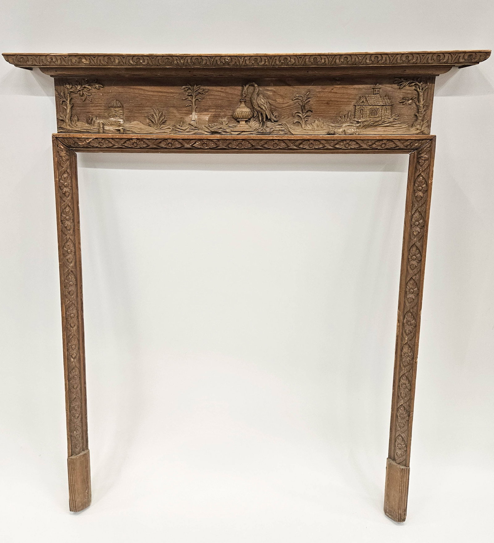 CARVED SCENIC WOOD MANTEL: Church / cottage with garden, heron; losses to relief including on bird; 45" x 41", G-VG