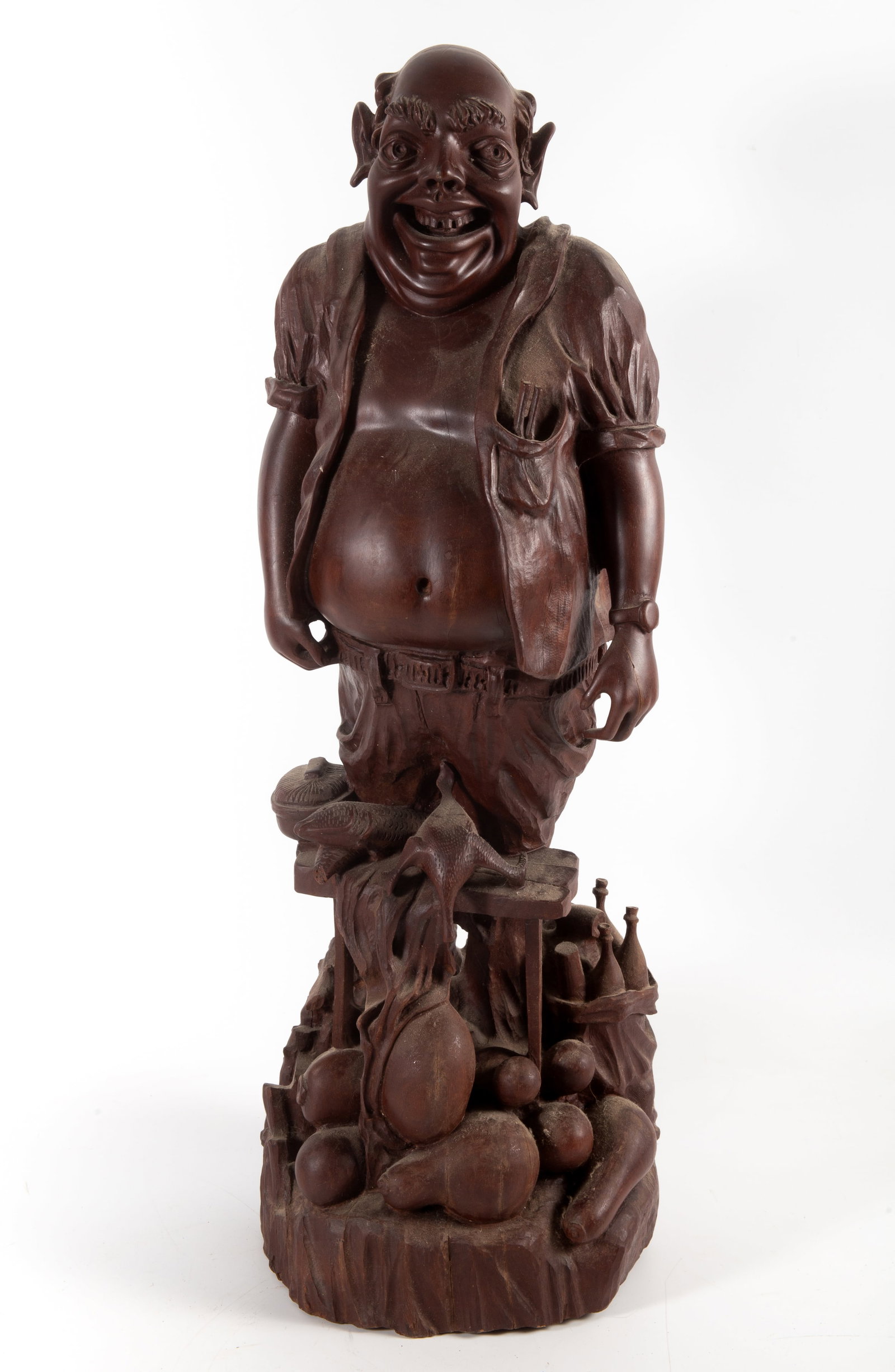 JOLLY COOK WOOD CARVING: Tropical wood carving with character man, food motif; old hand repair; minor shrinkage; 24" x 8" x 6 1/2", VG-EX