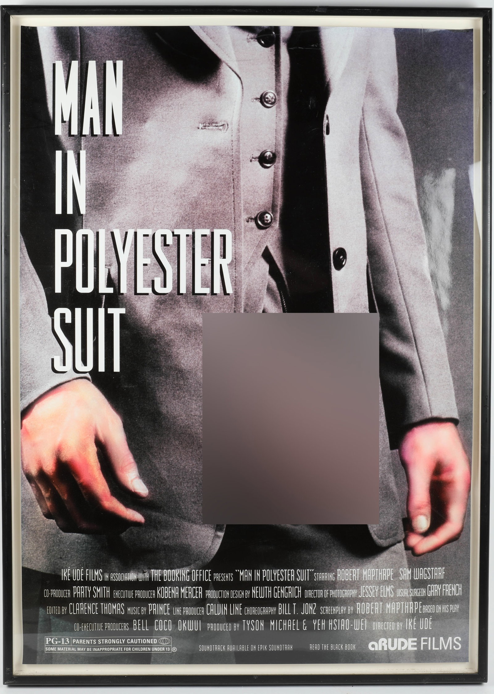 IKE UDE POSTER: "Man in Polyester Suit" framed wood and acrylic; Nollywood poster; miscellaneous wear and tear to frame; scratches to acrylic; 50" x 36", G-VG