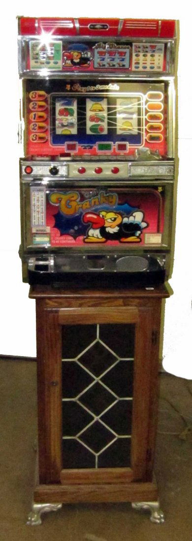 UNIVERSAL SLOT MACHINE: "Contest Cranky"; electric; together with oak and leaded glass stand; H-66", W-18", G-VG