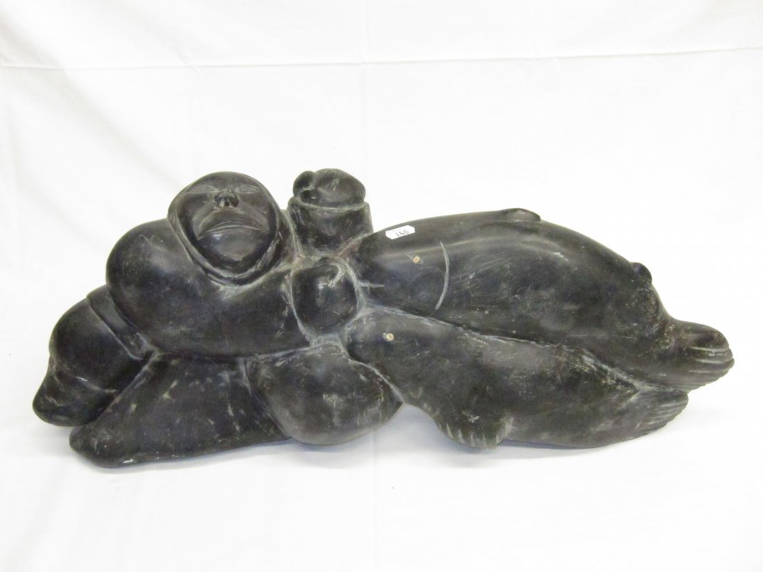 INUIT ART: Large soapstone carving of Eskimo, walrus and whale with carved face on reverse, doesn't appear to be signed; some scratches and wear. H-11", L-25", G-VG