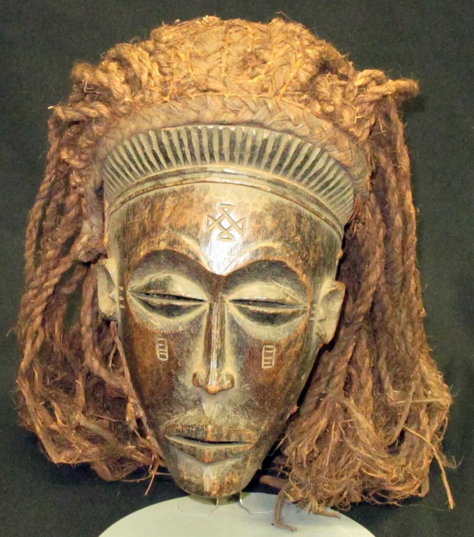 AFRICAN TRIBAL MASKS (4): (1) carved wood with raffia beard, L-11"; (1) possibly Pende: carved wood with raffia beard, L-12"; (1) possibly Chokwe (Angola): carved wood with long rope "hair", mask fitted with woven mesh interio