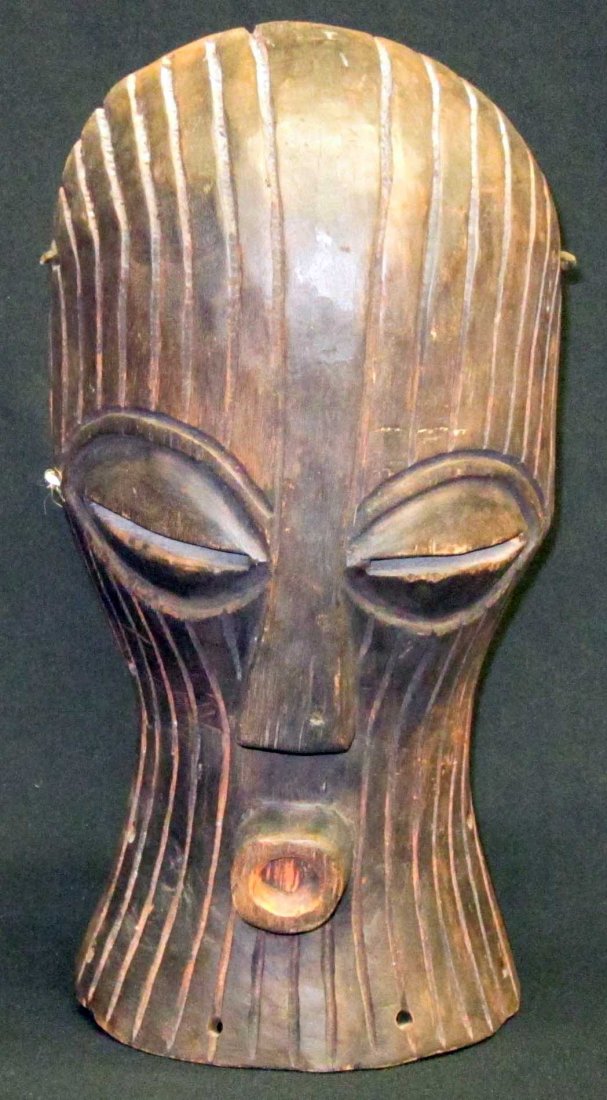 AFRICAN TRIBAL MASKS (4): (1) Possibly Dogon (Mali): polychrome painted carved wood, spotted mask with some abrasions, L-12"; (1) possibly Songye: carved wood with prominent incised lines, L-14 1/2"; (1) tribal mask: carved wo