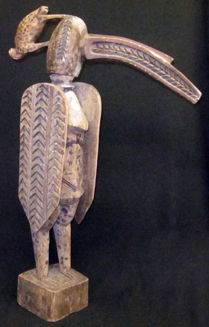 AFRICAN TRIBAL SCULPTURES (2): (1) storage container: carved wood with figural top and footed base, large check in wood base, H-25"; (1) Calao figure Senufo (Northern Cote d'Ivorie / Mali), carved wood with polychrome decoration, a