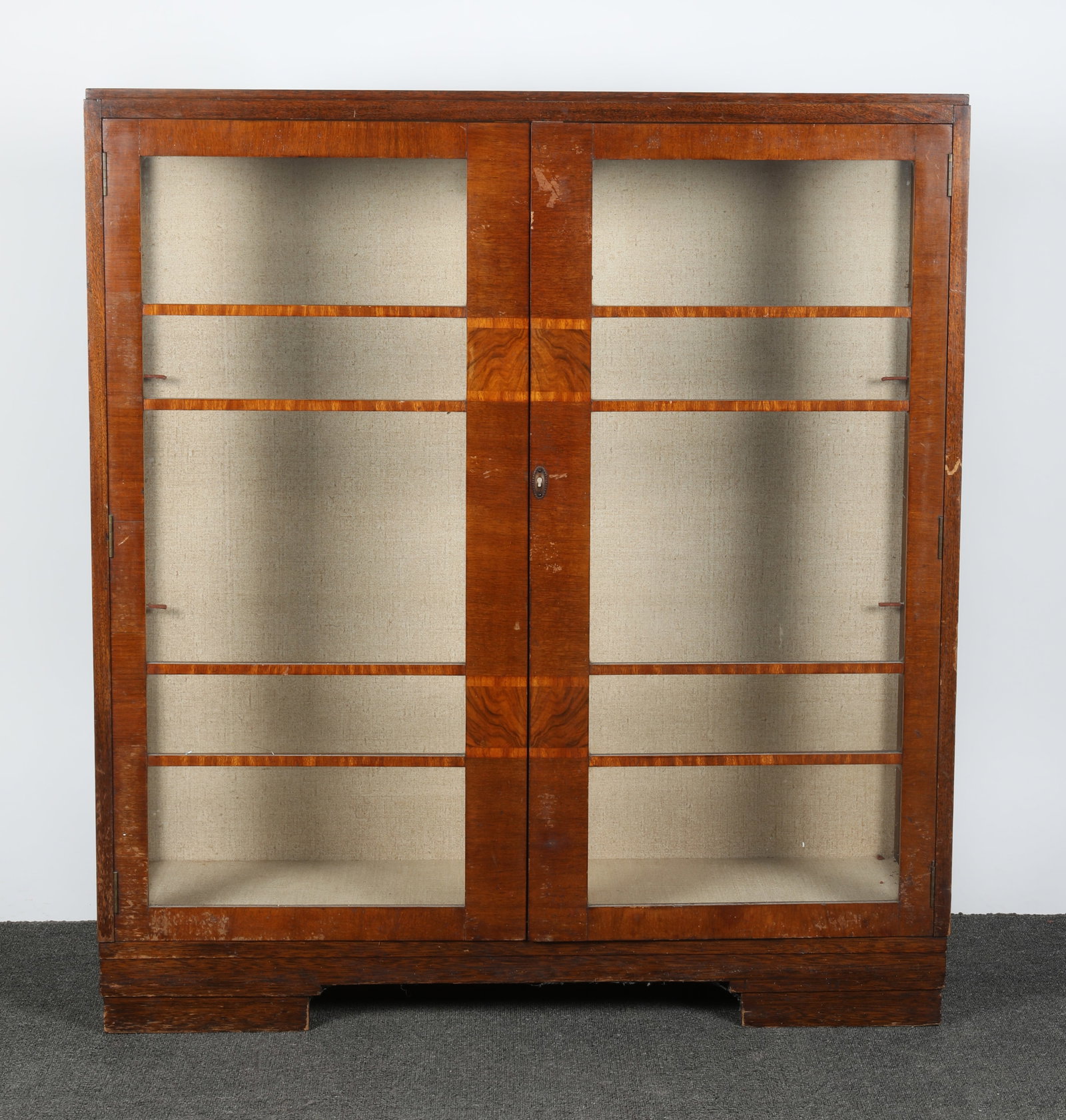 ART DECO DISPLAY CABINET: Walnut and mixed wood; double door; H-51"xW-42"; wear, finish rubs, (1) small glass panel cracked, F