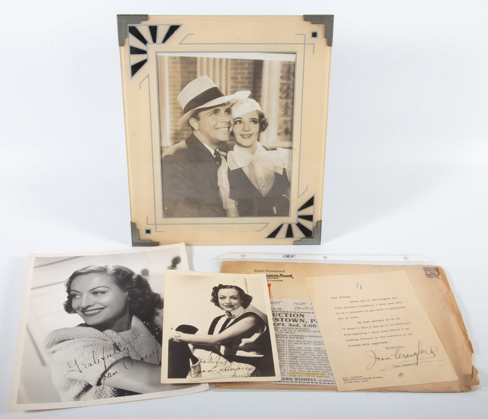 JOAN CRAWFORD PHOTOS/AUTOGRAPHS: (2) small photos with autographs; (1) large framed photo; (1) MGM envelope with Crawford signed letter; largest photo 10"x8", G
