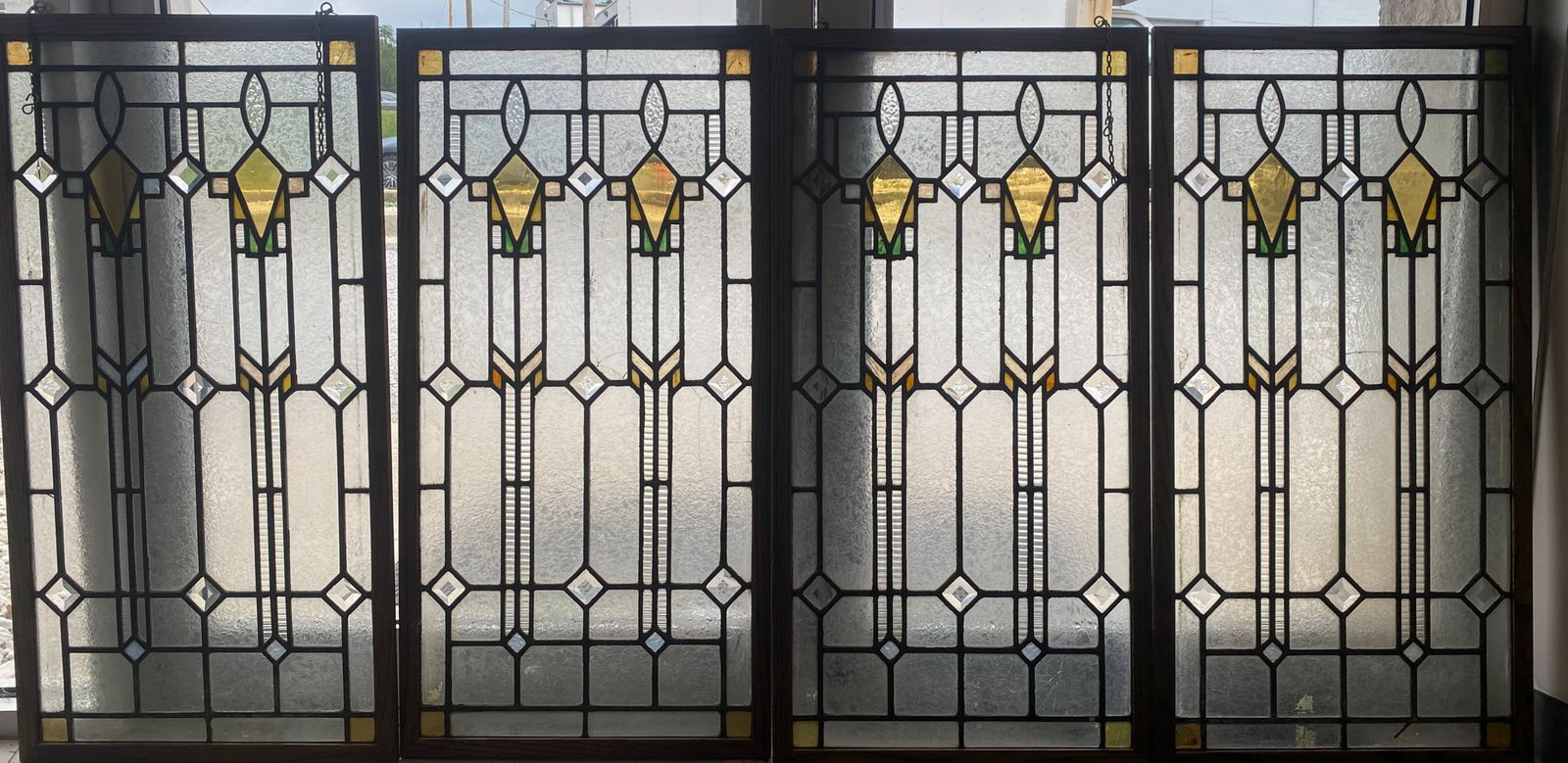 (4) LEADED AND STAINED GLASS PANELS: Ste of (4); geometric form with some rippled and beveled glass pieces; oak frame; 37"x19"; (2) panels have cracks; normal wear, G