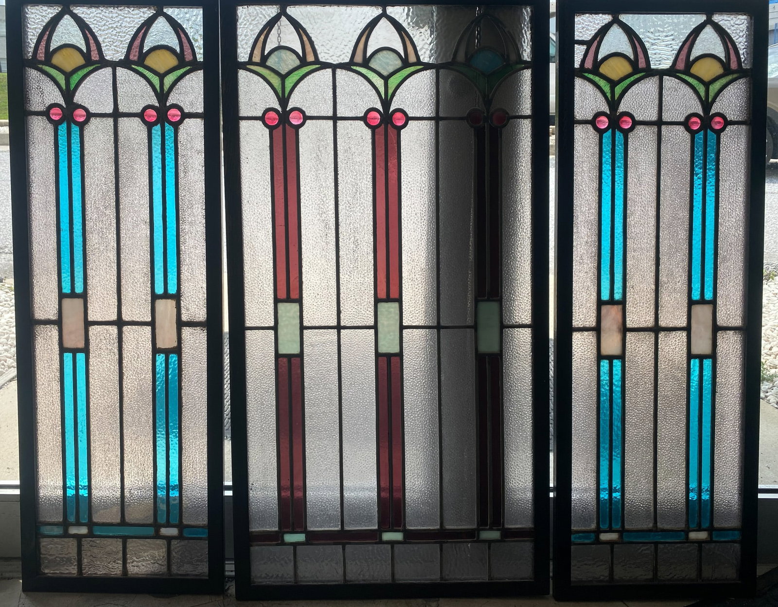 (3) LEADED AND STAINED GLASS PANELS: Tryptic form; (1) large panel between pair of smaller panels; bungalow-style arts and crafts; rippled and pimpled glass; wood frame; enter panel 37 1/2"x20", side panels 37 1/2"x13"; normal wear, G
