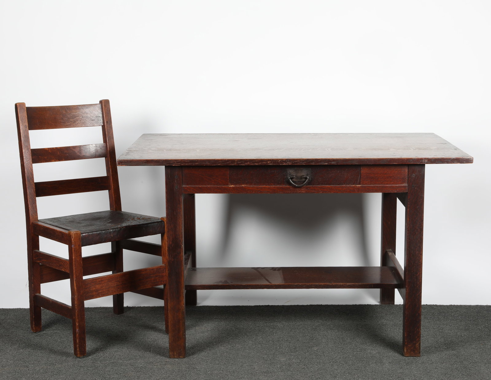 MISSION TABLE AND CHAIR: Oak - unsigned; table has single drawer; pegged construction; together with a ladderback chair with table; leather seat; H-29"xW-48"; normal wear, G-VG